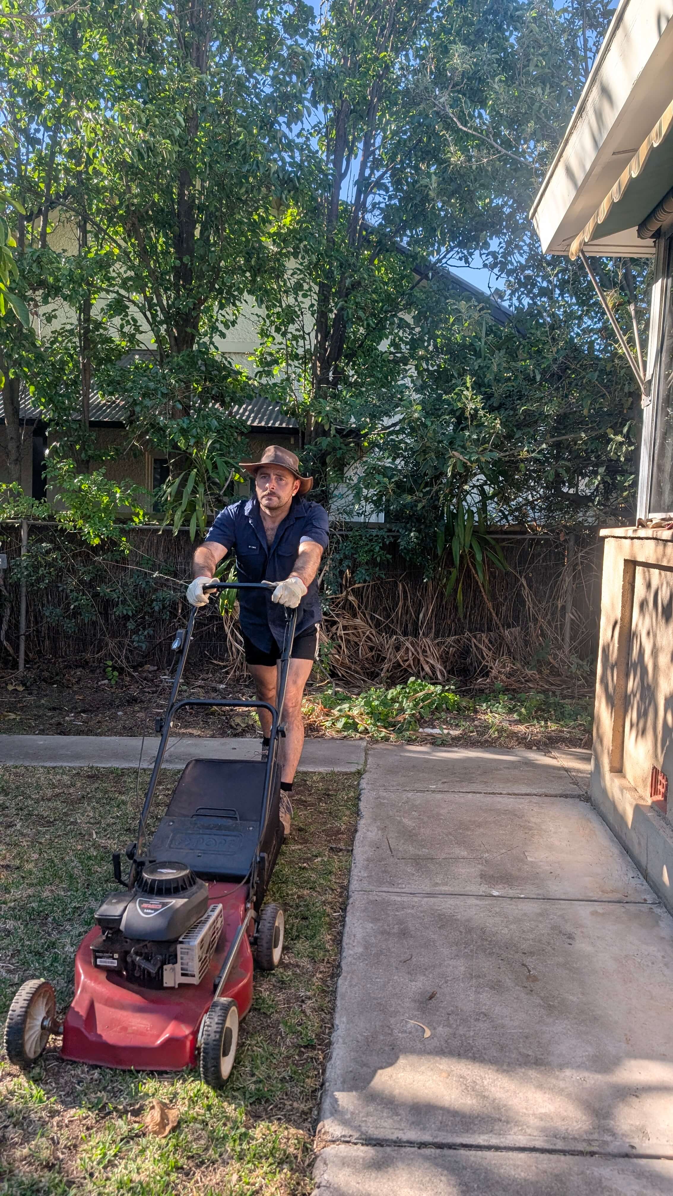 Aaron mowing lawn and maintaining yard